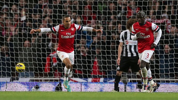 Theo Walcott celebrates putting Arsenal into a 4-3 lead