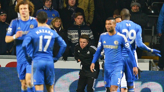 Eden Hazard looks at the injured ballboy 