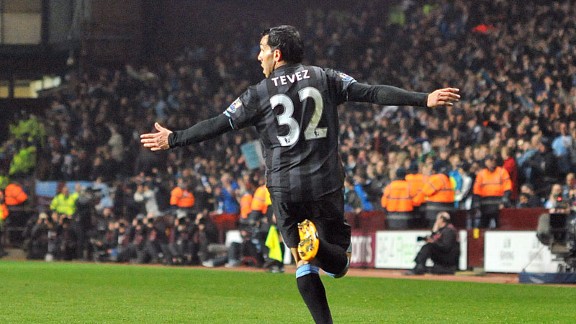 Carlos Tevez wheels away in delight after scoring the goal which led Man City to victory at Aston Villa
