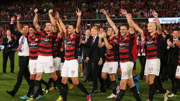 Western Sydney Wanderers captain Michael Beauchamp holds the Premiers' Plate after the victory over Brisbane Roar