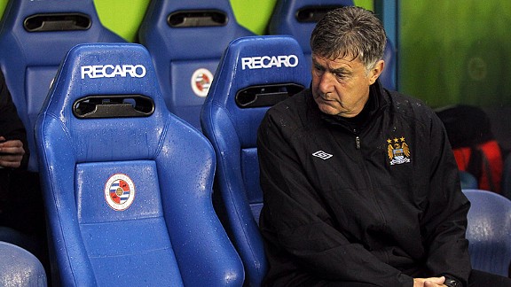 Brian Kidd is a lonely figure as he glances across the Man City bench