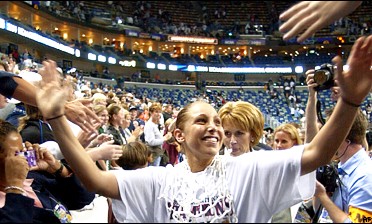 Nothing but net: UConn's Diana Taurasi celebrates her third straight national title.