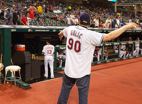 Golic warms up by tossing balls into the stands.